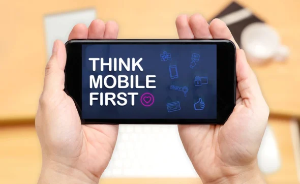 A man holding a mobile displaying a key message on how to find mobile-first design help for startups to grow in Sydney, NSW.